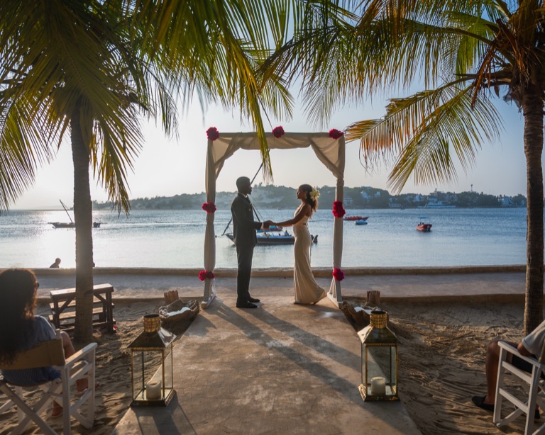 A candlelit beach wedding dinner at The Majlis